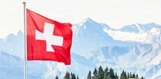 Swiss flag with mountain scenery